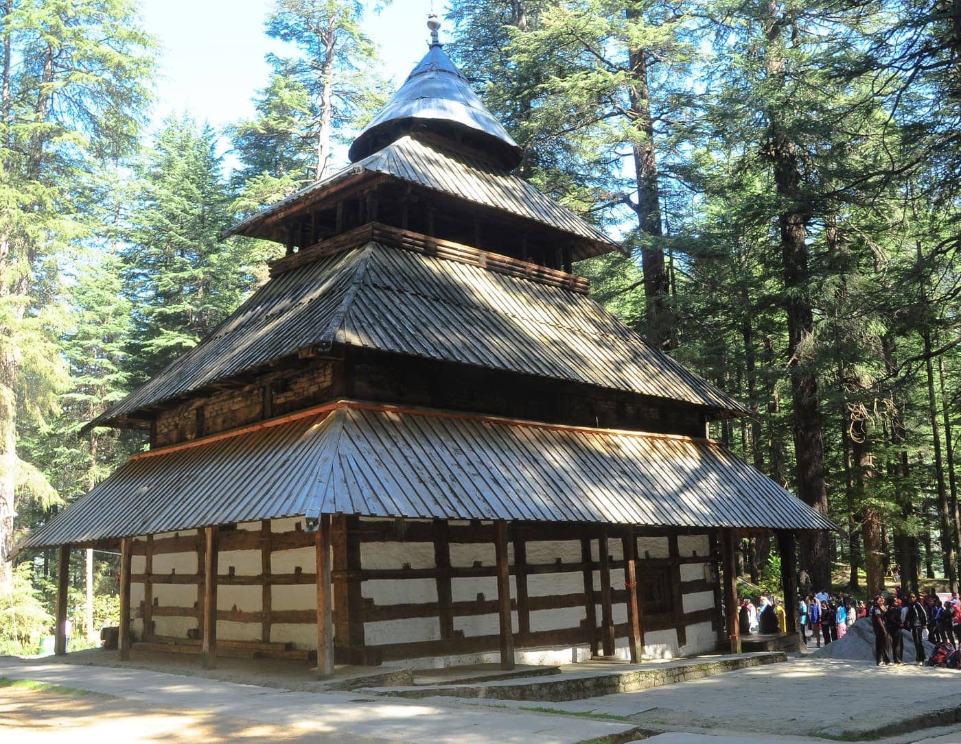 The tiered wooden pagoda roof of Hadimba Devi Temple among deodar trees in Manali
