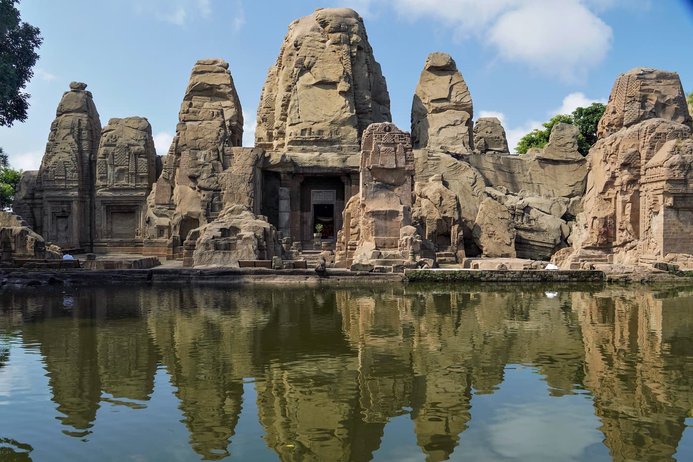 The monolithic rock-cut temples of Masroor reflected in their sacred pool