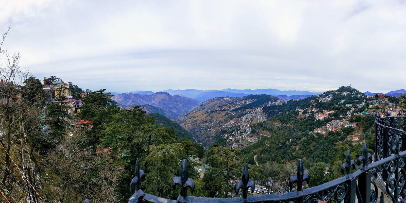 Forested ridges and hillside houses of Shimla seen from above
